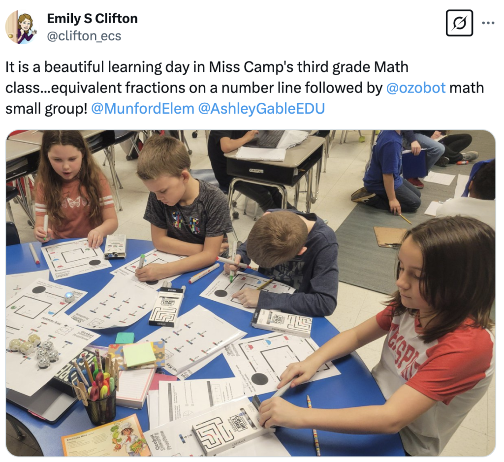 Third grade students us Ozobot in small groups to figure out fractions