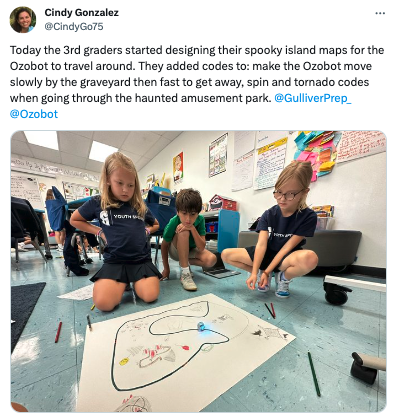 An image of students collaborating to design a spooky island map for their bots to travel around