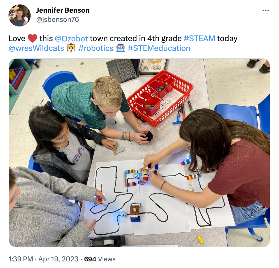 A picture showing students crafting a town on paper using color codes for Evo coding robot in this STEM lesson